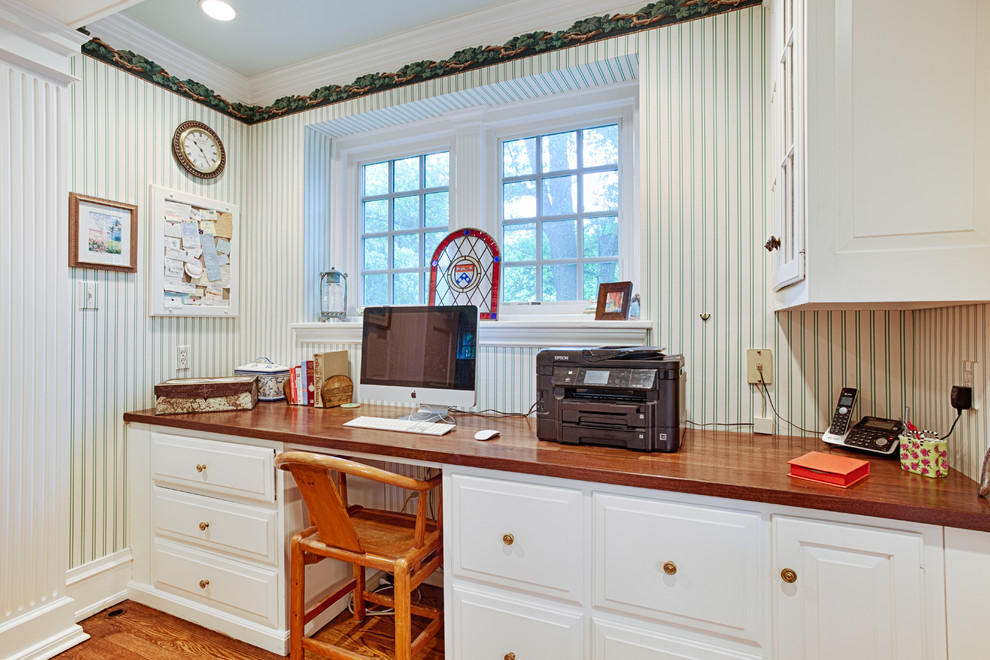 Modelo de despacho tradicional de tamaño medio con paredes blancas, suelo de madera clara y escritorio empotrado