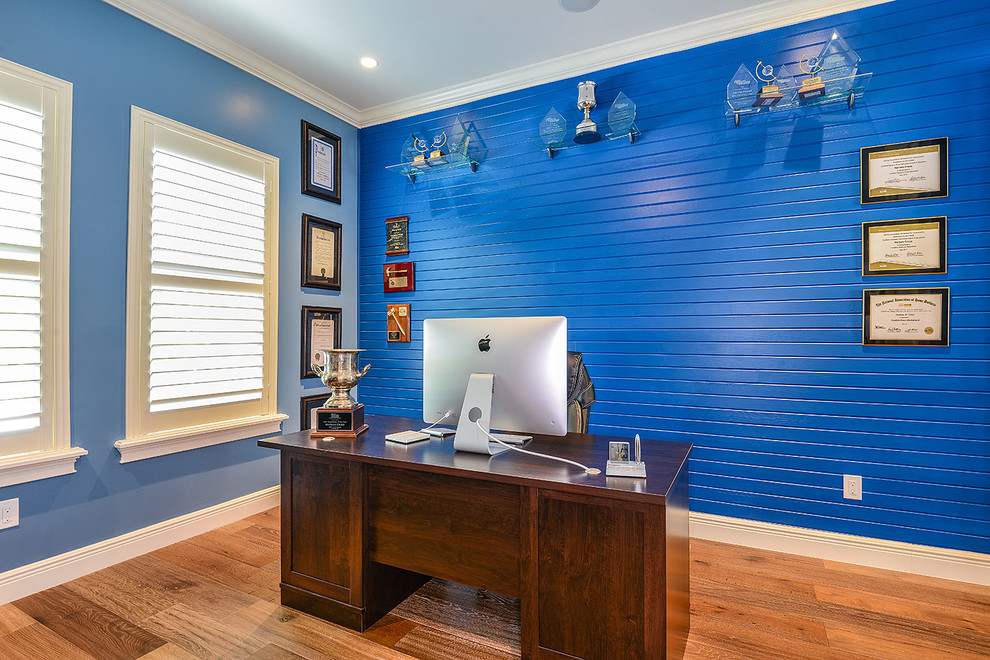 Photo of a medium sized classic home office in Tampa with blue walls, light hardwood flooring and a freestanding desk.