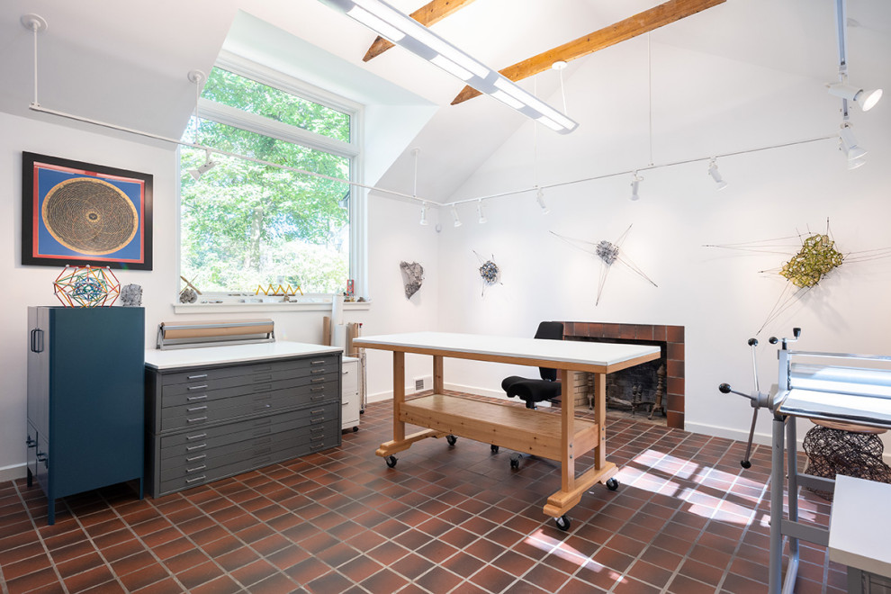 Photo of a large midcentury home studio in Philadelphia with white walls, terracotta flooring, a standard fireplace, a tiled fireplace surround, a freestanding desk and red floors.