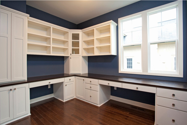 Inspiration for a large contemporary built-in desk medium tone wood floor study room remodel in Minneapolis with blue walls