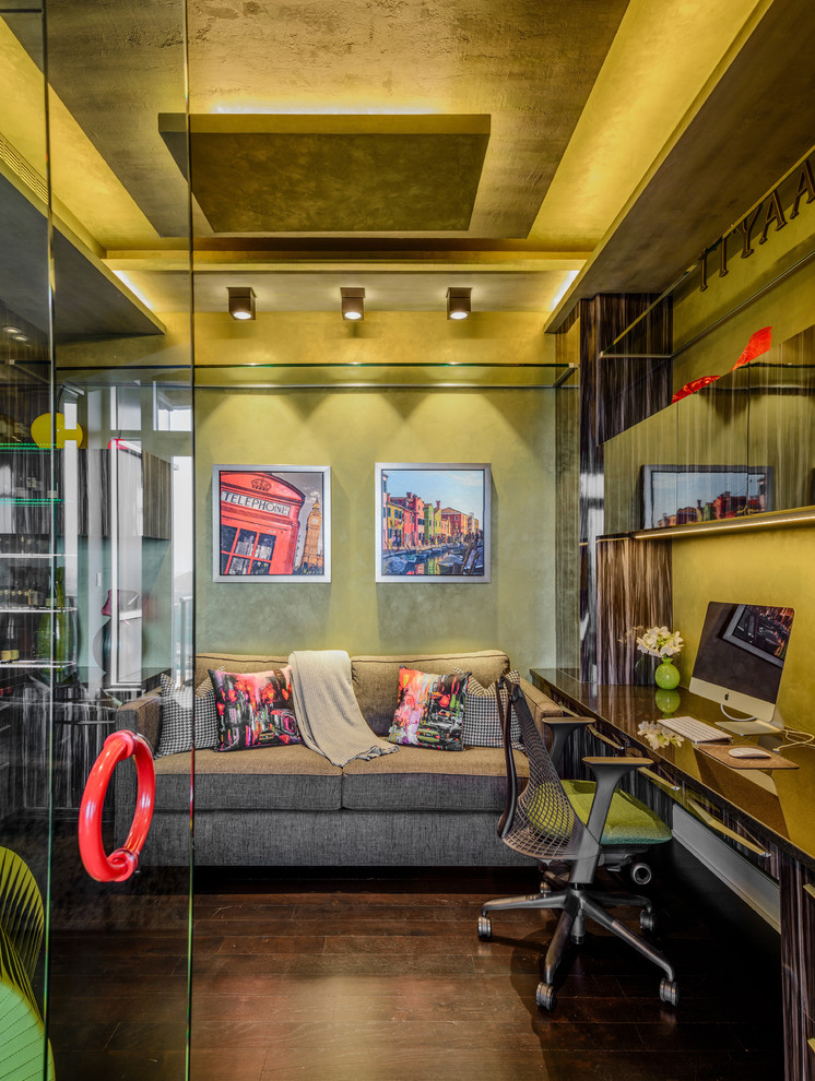 Inspiration for a contemporary study in Minneapolis with green walls, dark hardwood flooring and a built-in desk.