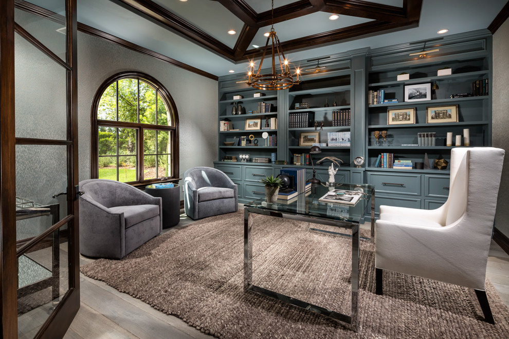 Example of a transitional freestanding desk light wood floor and beige floor home office library design in Los Angeles with gray walls