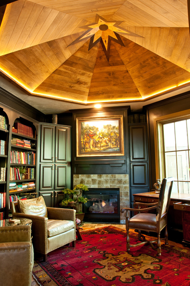 Study room - mid-sized traditional freestanding desk dark wood floor study room idea in Denver with black walls, a standard fireplace and a tile fireplace