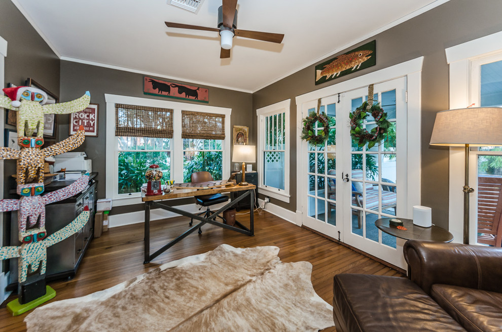 Photo of a bohemian study in Tampa with brown walls, medium hardwood flooring, a freestanding desk and brown floors.