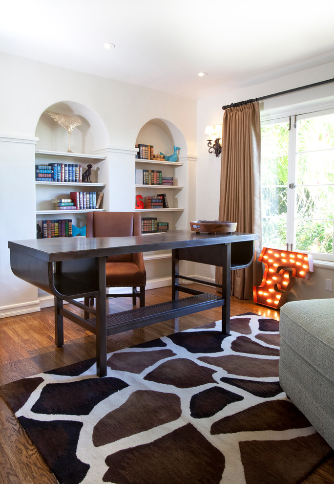 Transitional freestanding desk dark wood floor home office photo in Los Angeles with white walls