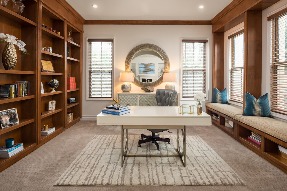 Home office library - transitional freestanding desk carpeted and beige floor home office library idea in San Diego with beige walls and no fireplace