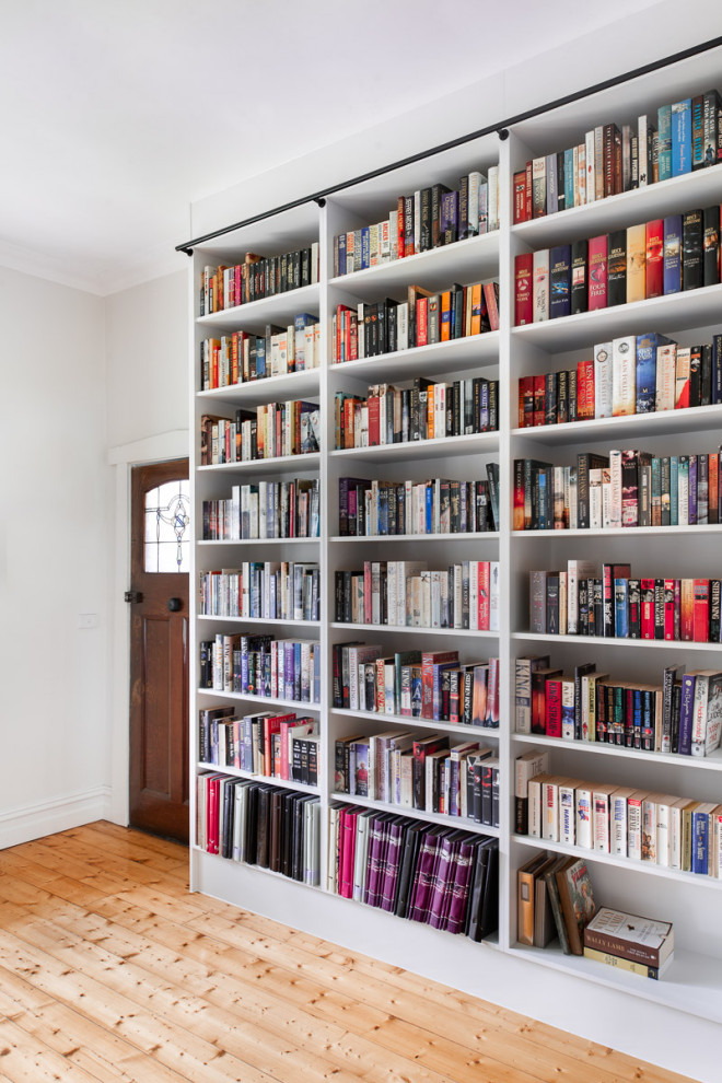 Example of a large trendy home office library design in Melbourne