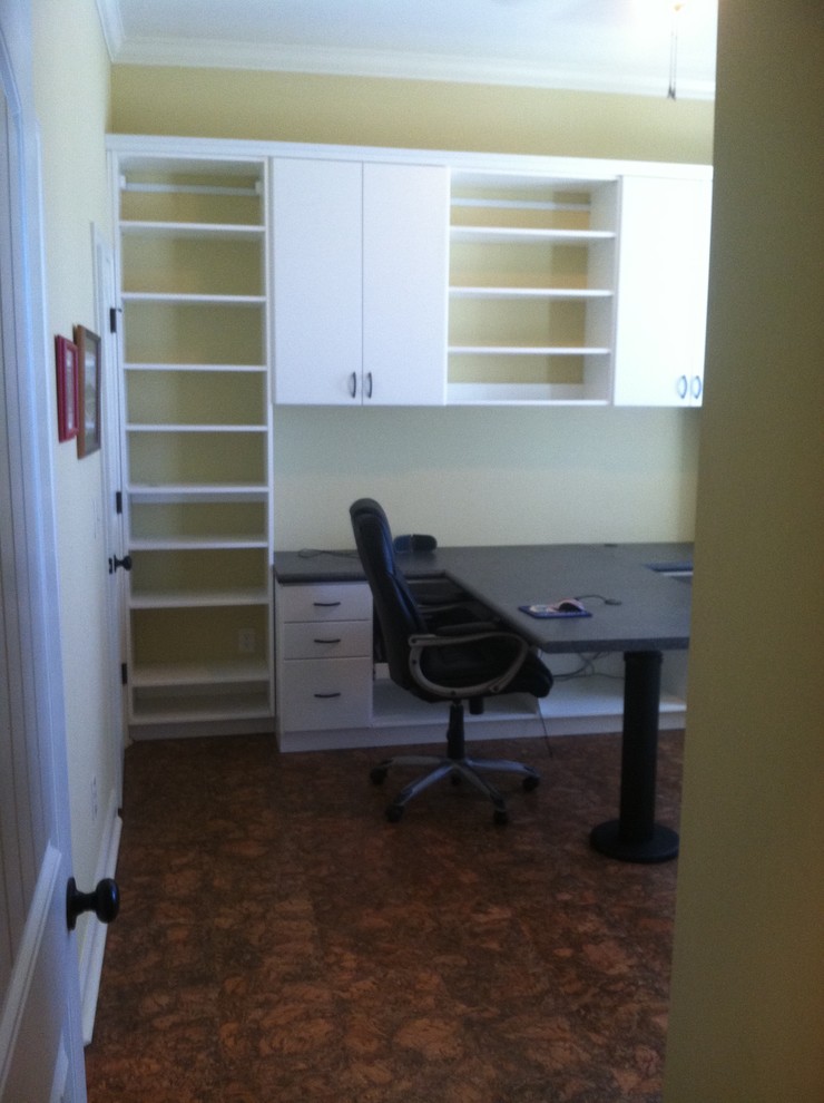 Photo of a medium sized traditional home office in Birmingham with yellow walls, a built-in desk and brown floors.