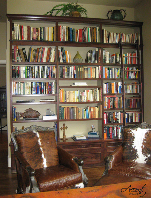 This is an example of a medium sized classic study in Houston with beige walls, medium hardwood flooring and a built-in desk.