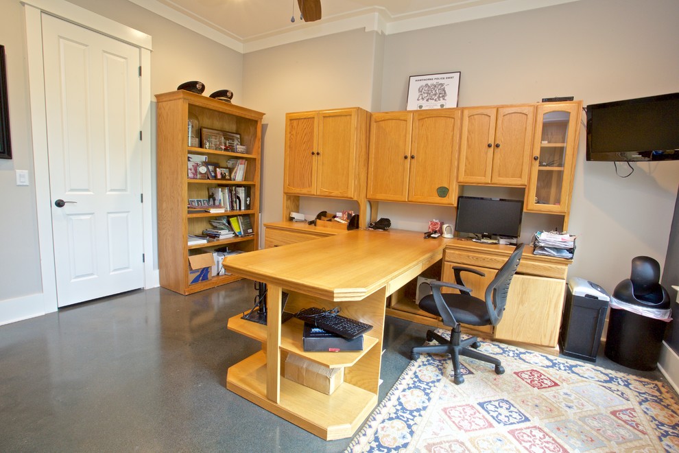 Study room - mid-sized transitional built-in desk linoleum floor study room idea with beige walls and no fireplace