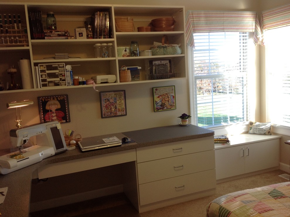 Mid-sized trendy built-in desk carpeted study room photo in Other with beige walls