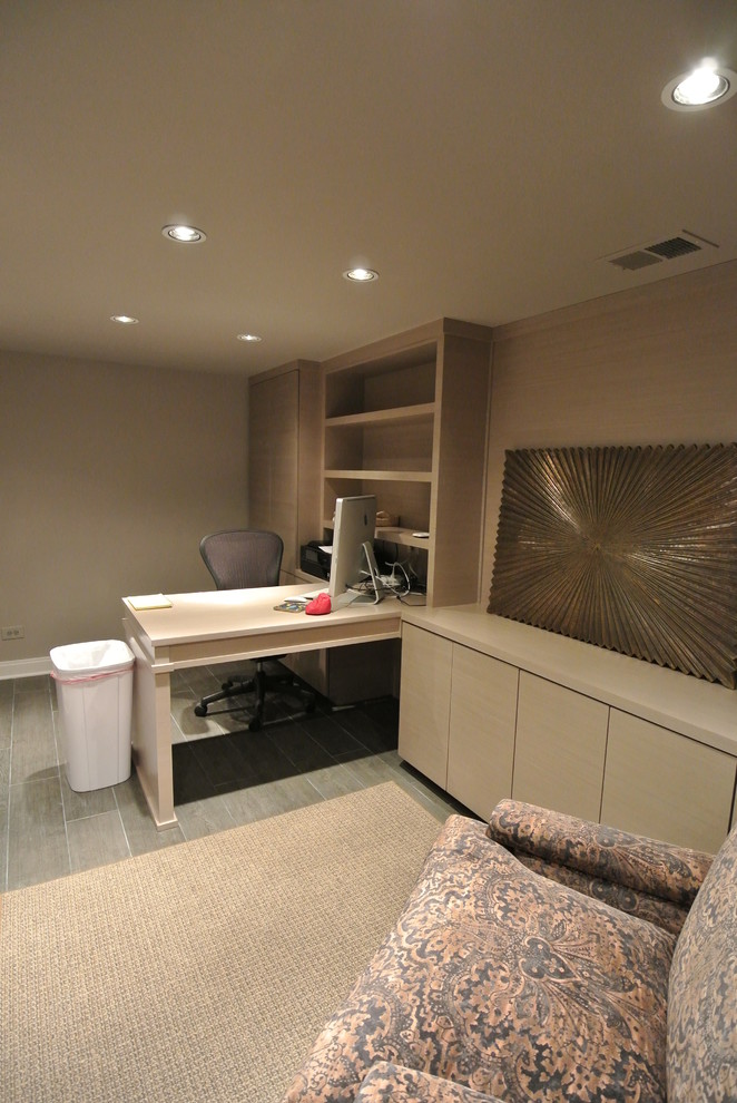 Photo of a contemporary home office in Chicago with beige walls and a built-in desk.