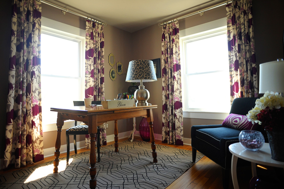 Trendy freestanding desk medium tone wood floor home office photo in Baltimore with brown walls