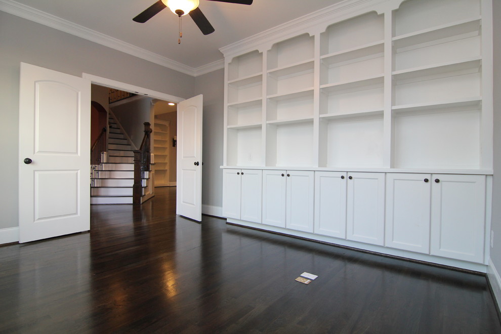Study room - large traditional medium tone wood floor study room idea in Raleigh with gray walls