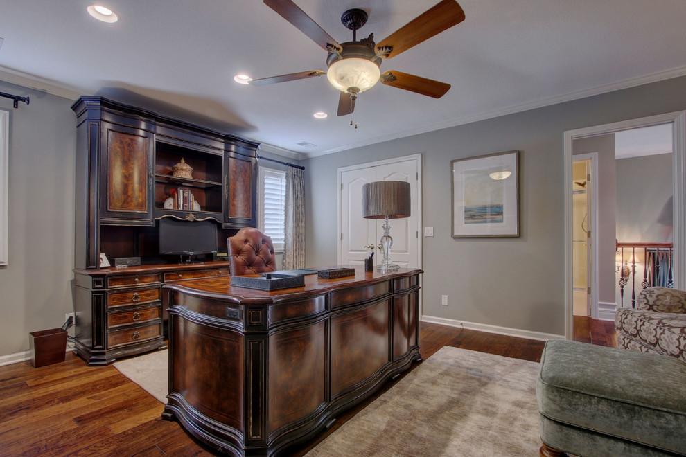 Mid-sized elegant freestanding desk dark wood floor study room photo in Kansas City with gray walls and no fireplace