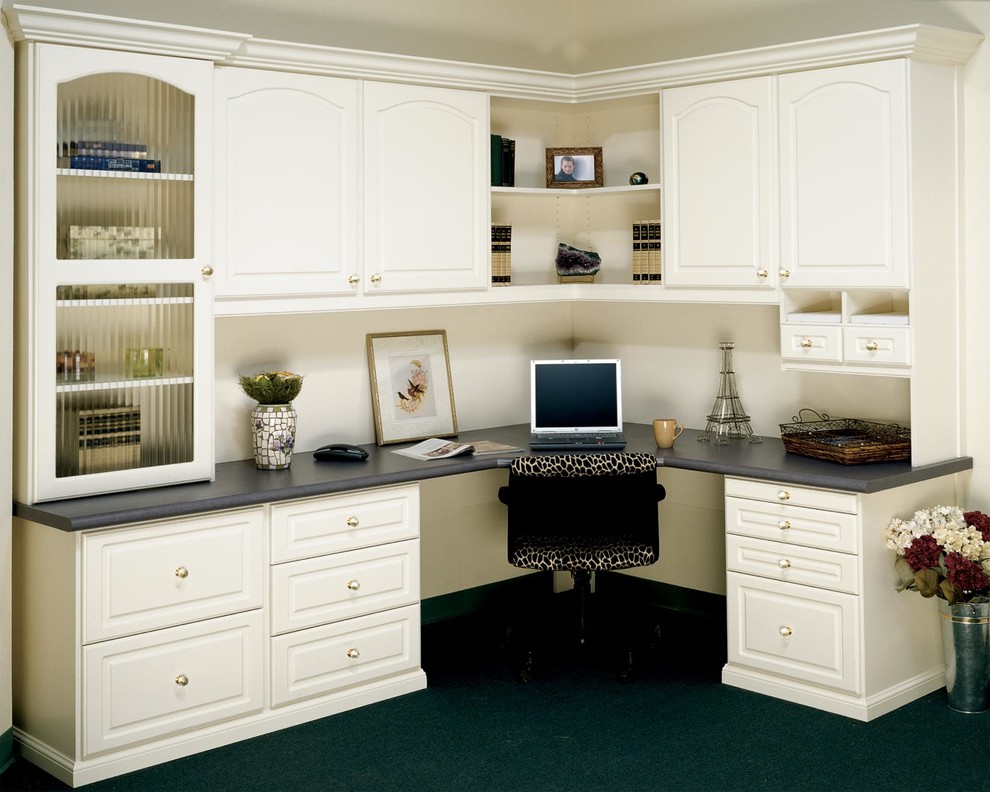 This is an example of a medium sized classic study in Louisville with white walls, no fireplace, a built-in desk and black floors.