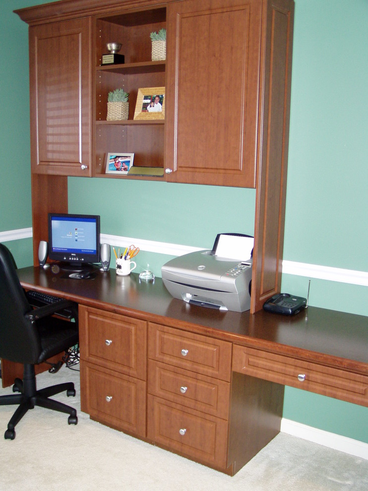 Study room - mid-sized traditional built-in desk carpeted study room idea in New York with green walls