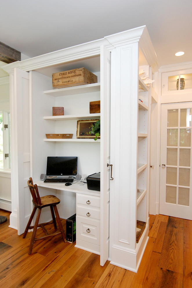 Immagine di un grande ufficio design con pareti bianche, pavimento in legno massello medio e scrivania incassata