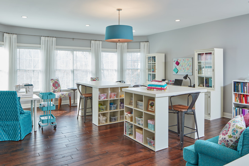 Example of a large classic freestanding desk medium tone wood floor craft room design in Baltimore with gray walls
