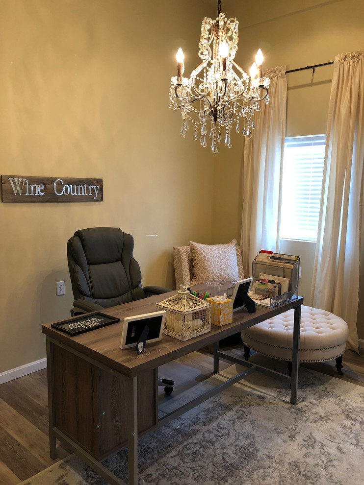 This is an example of a medium sized classic home office in Philadelphia with beige walls, laminate floors, a freestanding desk and grey floors.