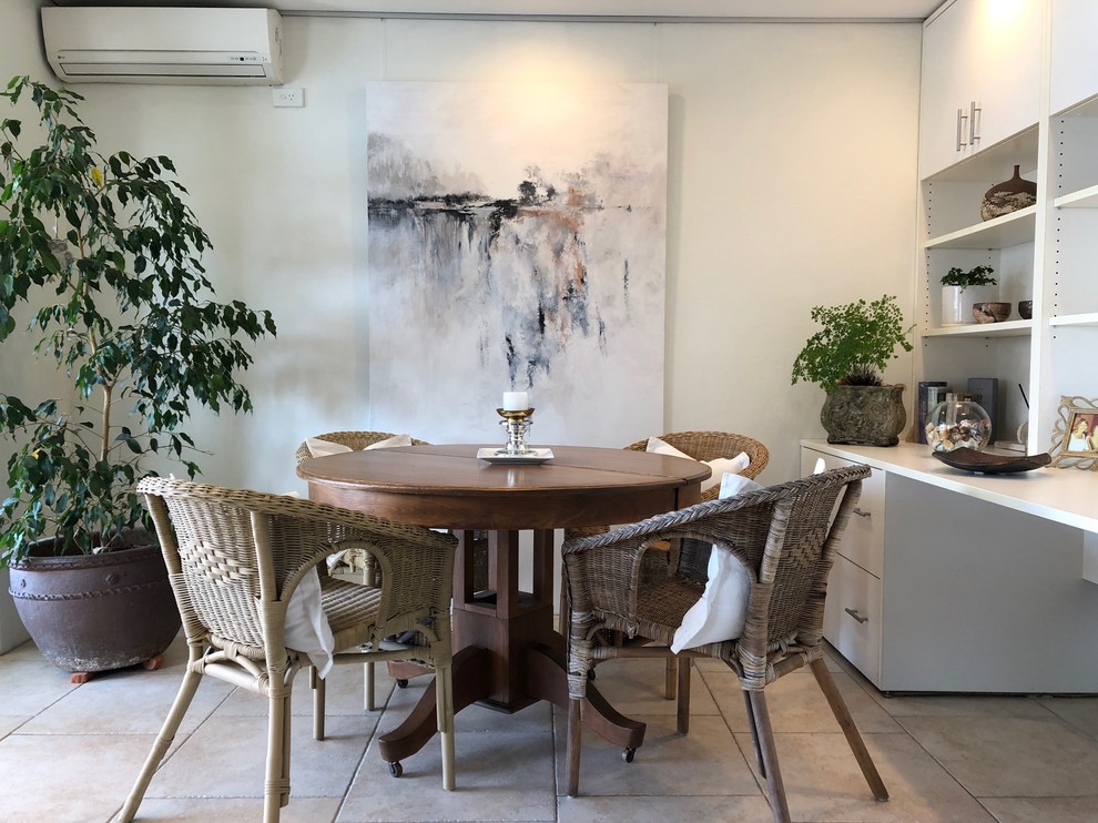 This is an example of a small bohemian dining room in Sydney with grey walls, porcelain flooring and beige floors.