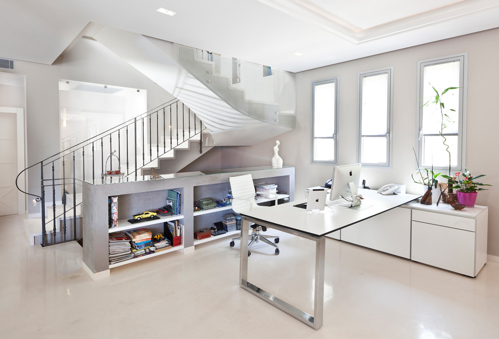 This is an example of a contemporary home office in Other with grey walls and a freestanding desk.
