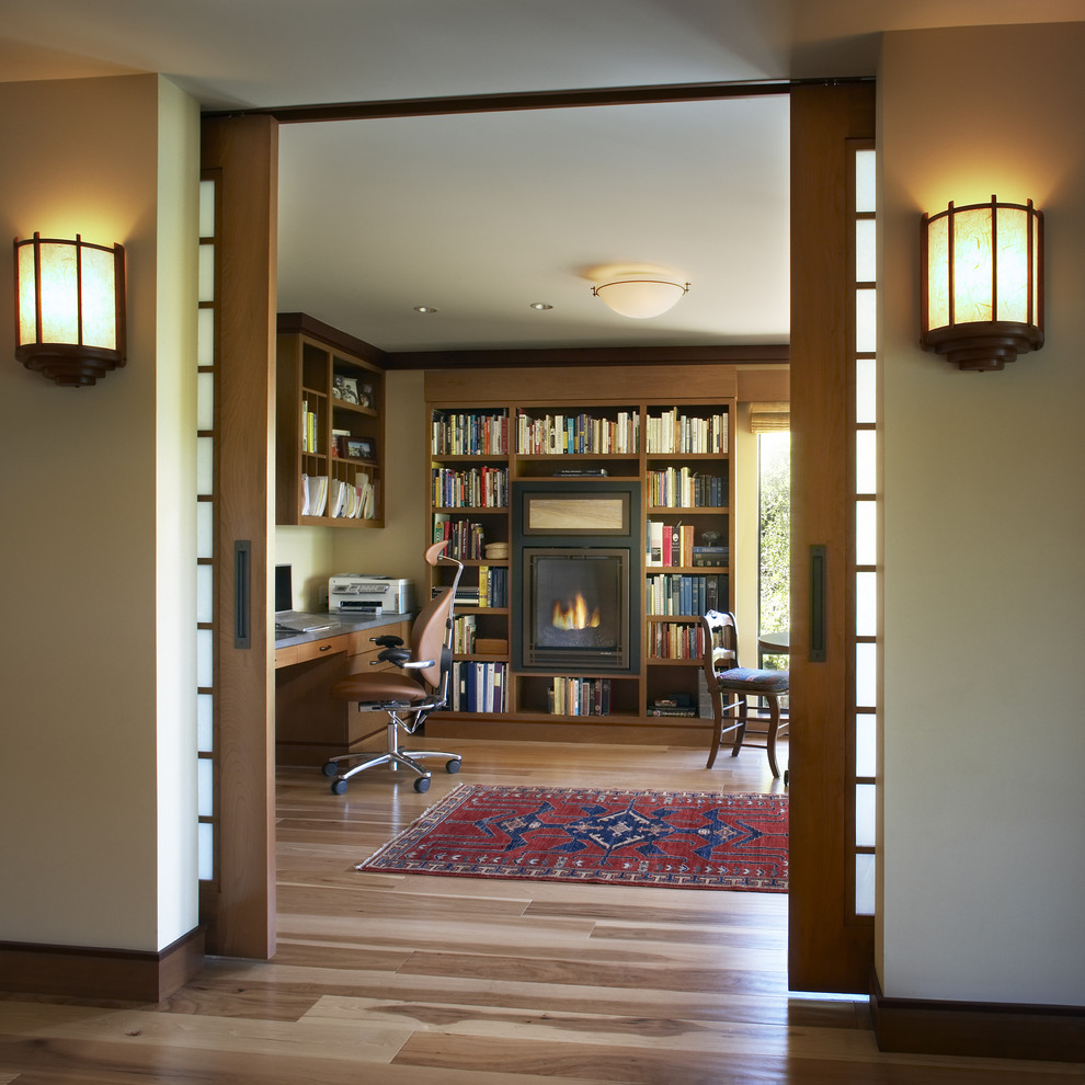 Home office - contemporary medium tone wood floor home office idea in San Francisco with beige walls