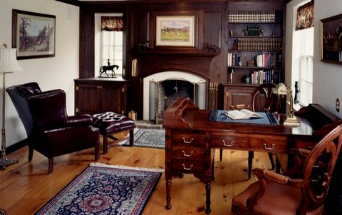 Study room - huge cottage freestanding desk medium tone wood floor study room idea in Philadelphia with white walls and a standard fireplace