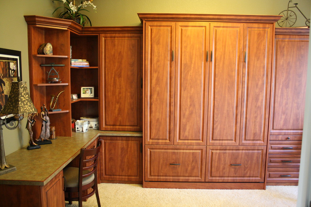 This is an example of a traditional study in Sacramento with beige walls, carpet and a built-in desk.