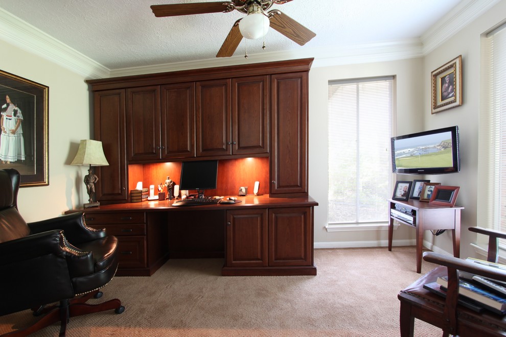 Medium sized traditional home office in Houston with beige walls, carpet, no fireplace, a built-in desk and beige floors.