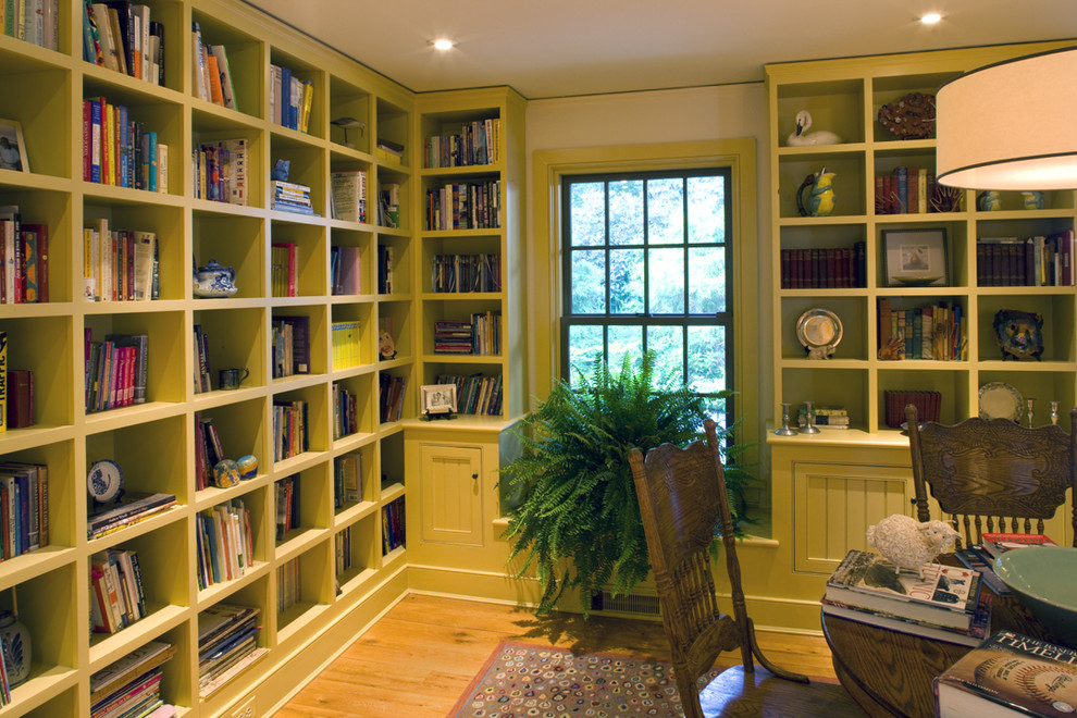 Elegant medium tone wood floor home office photo in Philadelphia with white walls