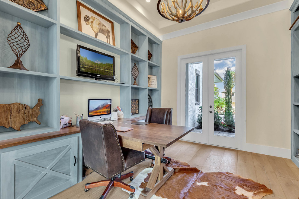 Photo of a large classic home studio in Orlando with grey walls, light hardwood flooring, a freestanding desk and grey floors.