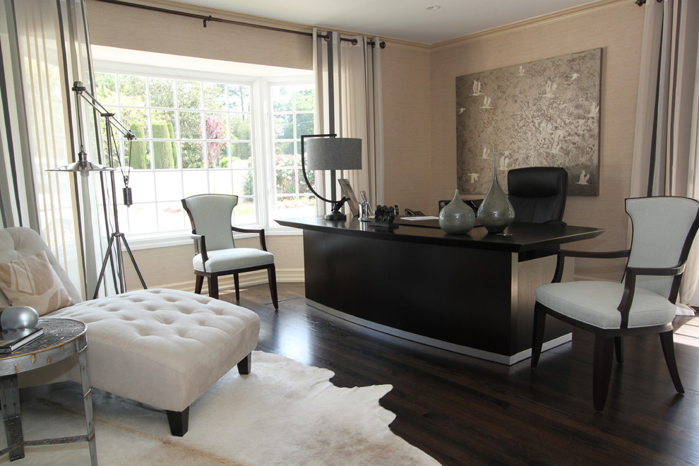 Example of a trendy freestanding desk dark wood floor home office design in San Francisco with beige walls