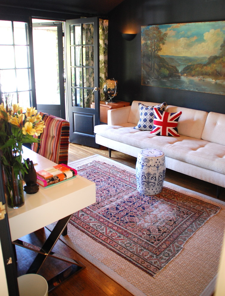 Inspiration for an eclectic home office in Los Angeles with black walls, dark hardwood flooring and a freestanding desk.