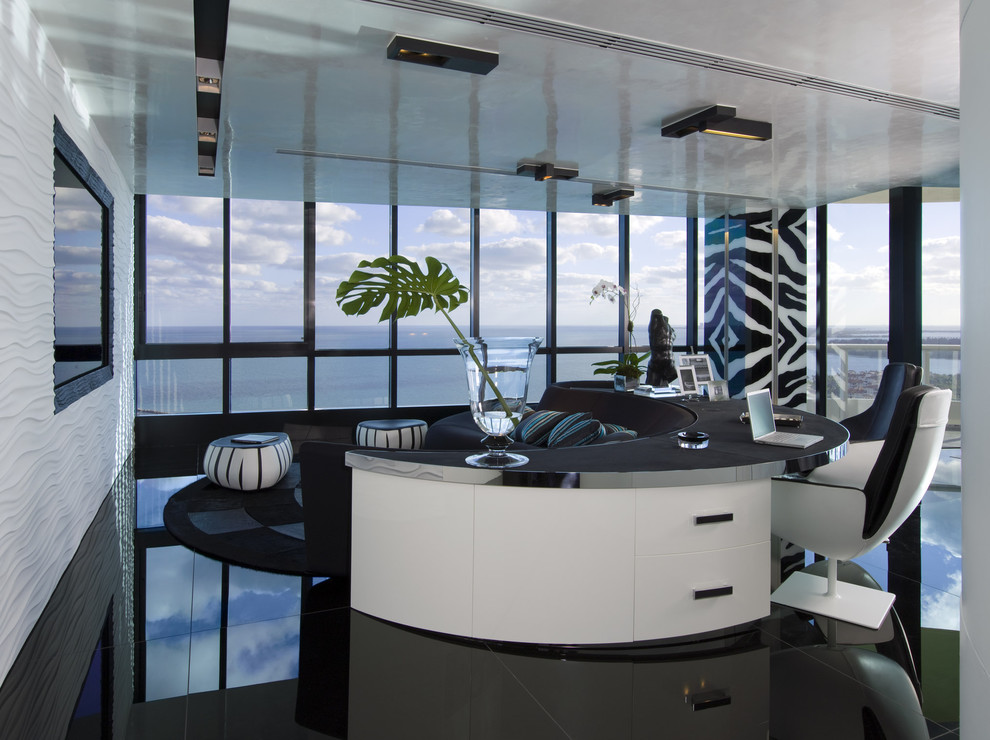 Example of a trendy freestanding desk black floor home office design in Miami with white walls