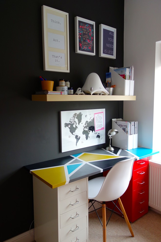 Photo of a small contemporary home office in Other with black walls, carpet and a freestanding desk.