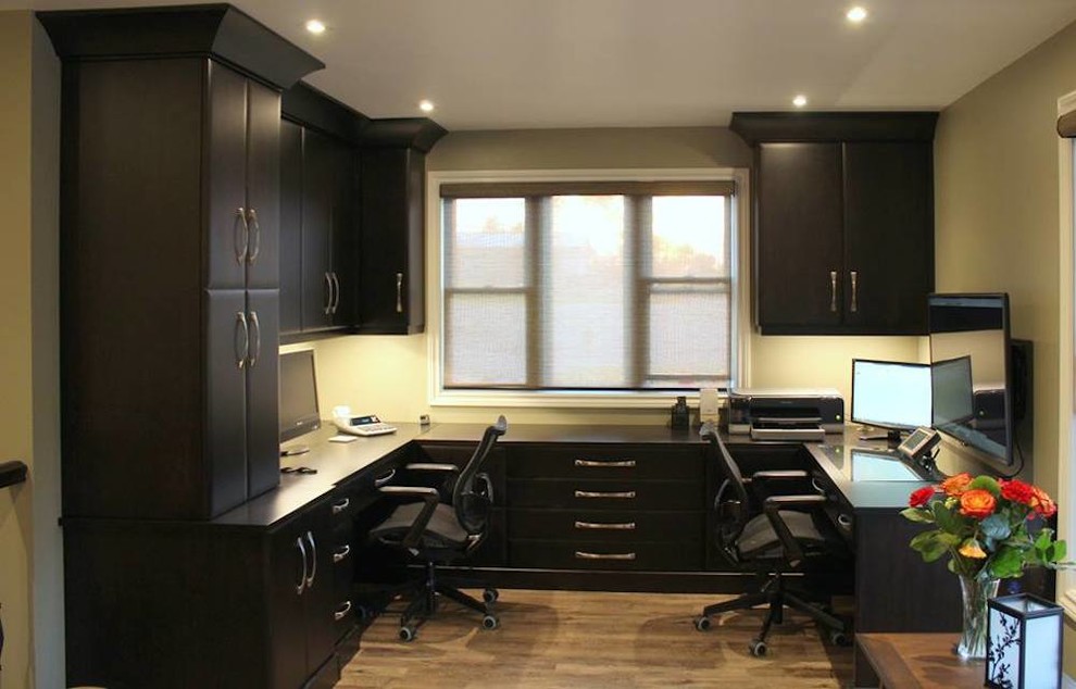 Home office - mid-sized contemporary built-in desk light wood floor home office idea in Other with beige walls and no fireplace