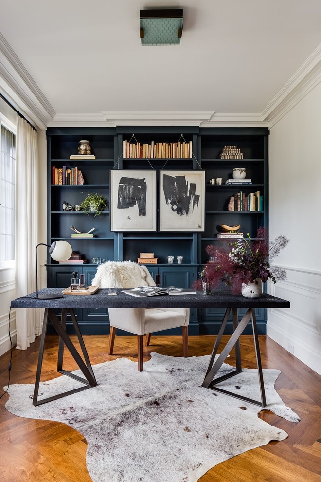 Inspiration for a mid-sized transitional freestanding desk medium tone wood floor and brown floor study room remodel in Boston with blue walls