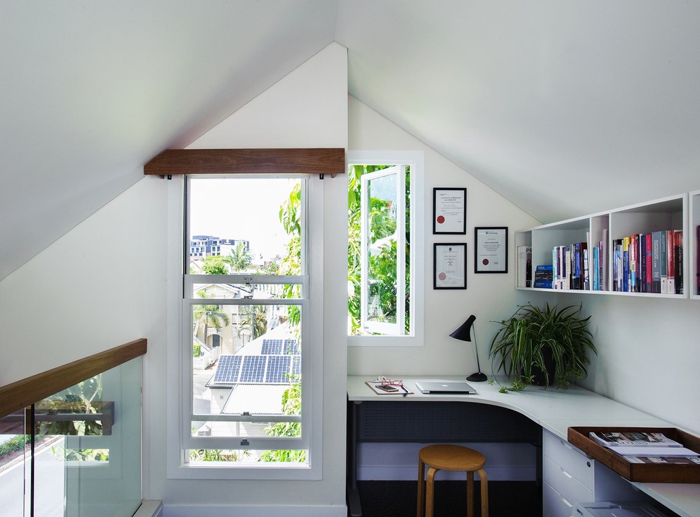 This is an example of a small contemporary study in Brisbane with white walls, lino flooring, a freestanding desk and black floors.