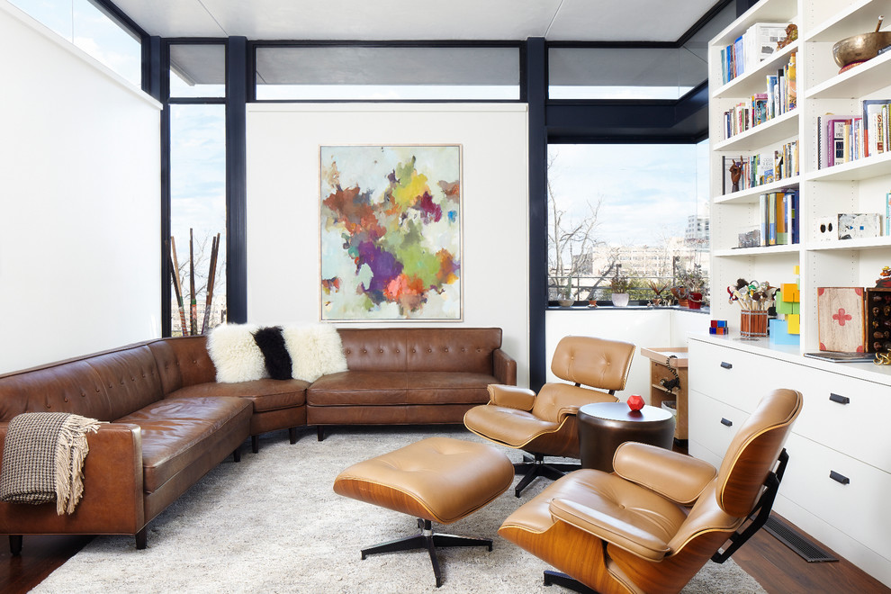 Imagen de despacho moderno con paredes blancas y suelo de madera en tonos medios