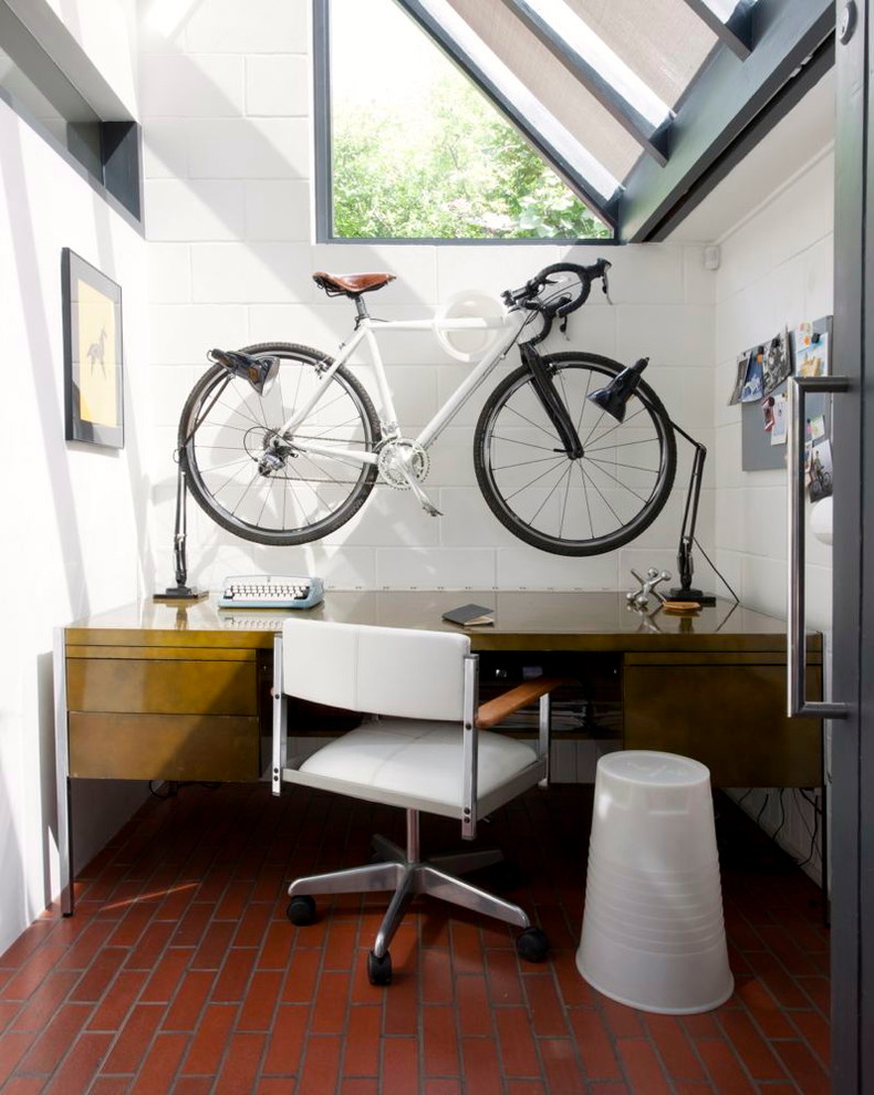 Inspiration for an industrial brick floor home office remodel in Hampshire