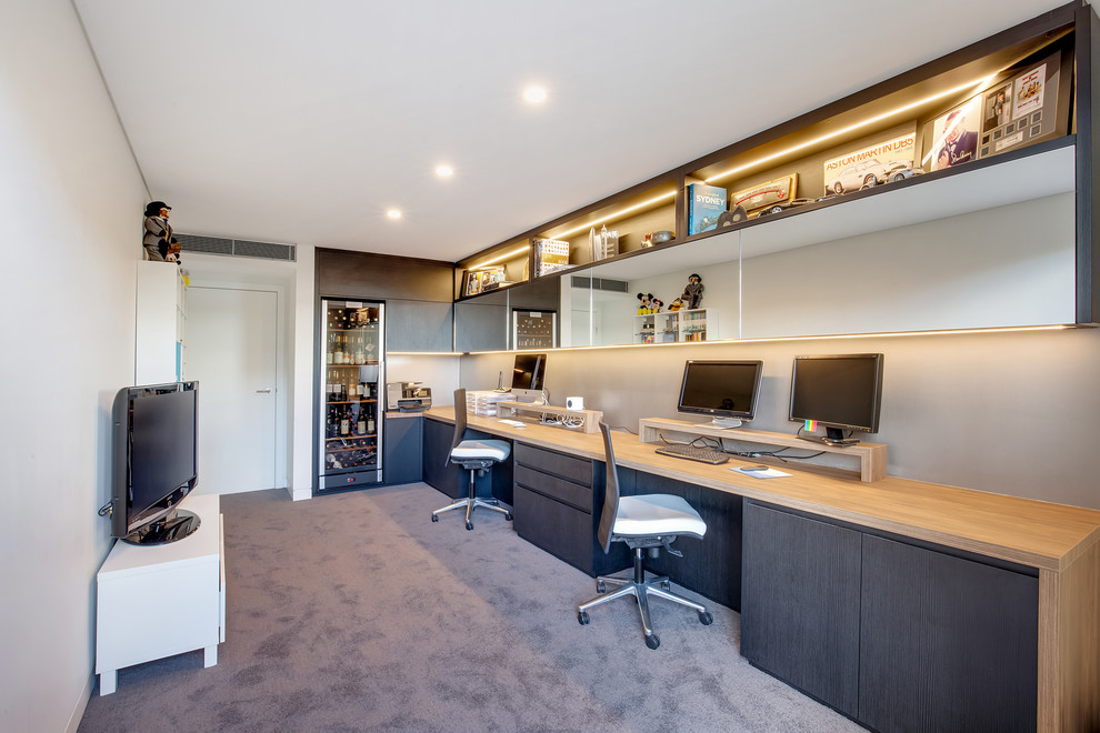 Photo of a medium sized contemporary study in Sydney with beige walls, carpet, a built-in desk and grey floors.