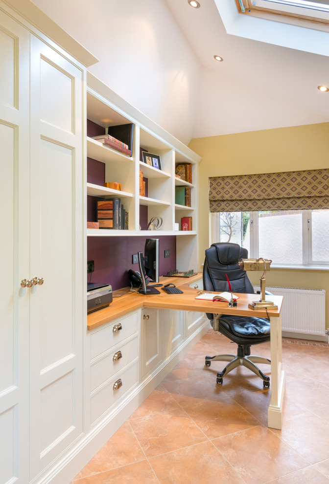 This is an example of a medium sized contemporary study in Dublin with multi-coloured walls, vinyl flooring, no fireplace and a built-in desk.