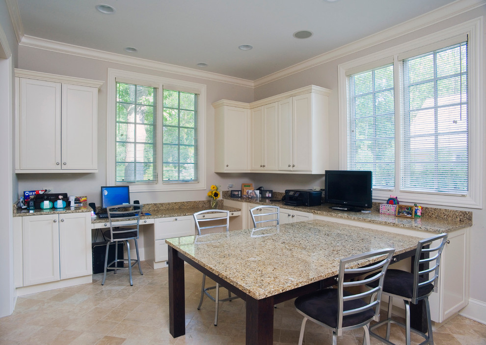 Example of a large transitional freestanding desk limestone floor craft room design in Chicago with white walls and no fireplace