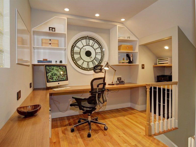Example of a mid-sized transitional built-in desk light wood floor and brown floor home office design in Newark with gray walls