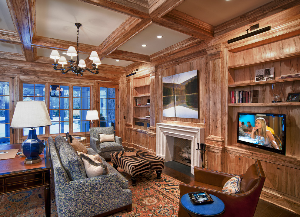 Inspiration for a large rustic freestanding desk dark wood floor and brown floor study room remodel in Cleveland with a standard fireplace, brown walls and a wood fireplace surround