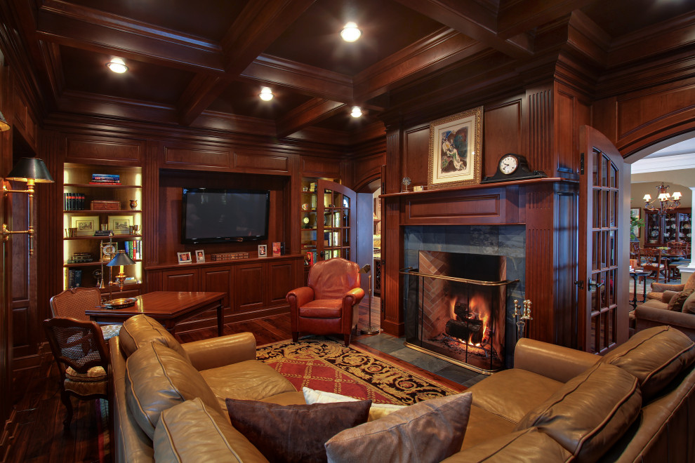 Inspiration for a large traditional study in Other with dark hardwood flooring, a standard fireplace, a stone fireplace surround, a freestanding desk, a coffered ceiling, panelled walls and a chimney breast.