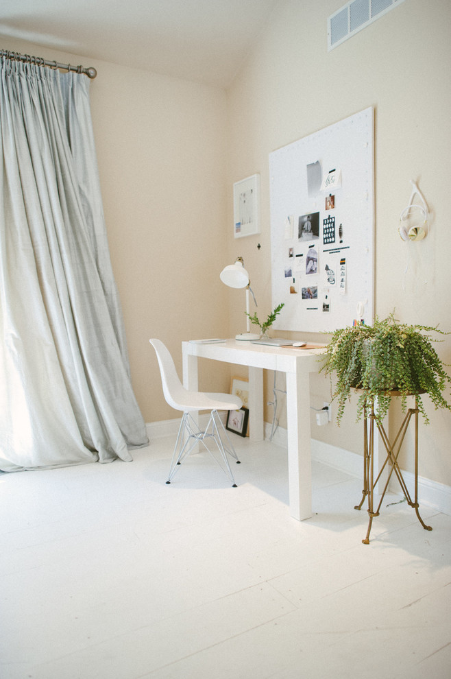 Medium sized bohemian home studio in Other with beige walls, light hardwood flooring and a freestanding desk.