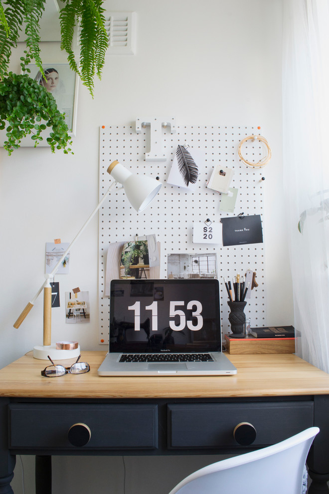 Example of a small danish freestanding desk study room design in Kent with white walls and no fireplace