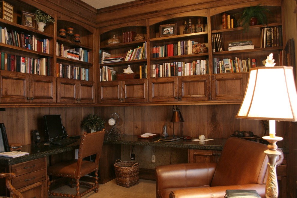Example of a tuscan built-in desk study room design in Boise